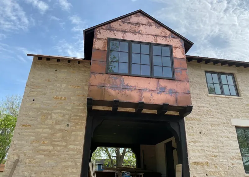 Copper metal panel facade on a stone building for Skylight Installation in Grosse Pointe Park