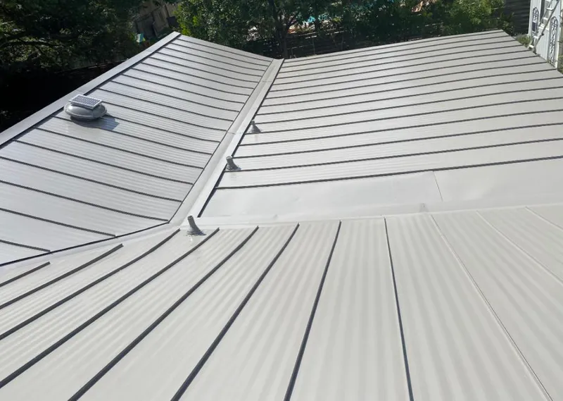 Solar attic fan installed on a metal roof for Roof Ventilation in Grosse Pointe Park