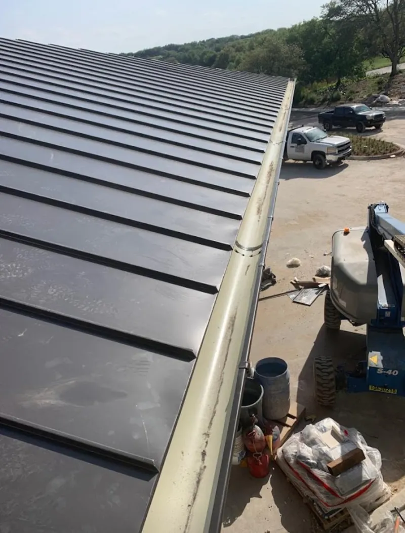 Standing seam panel and gutter detail on a metal roofing jobsite in Grosse Pointe Park